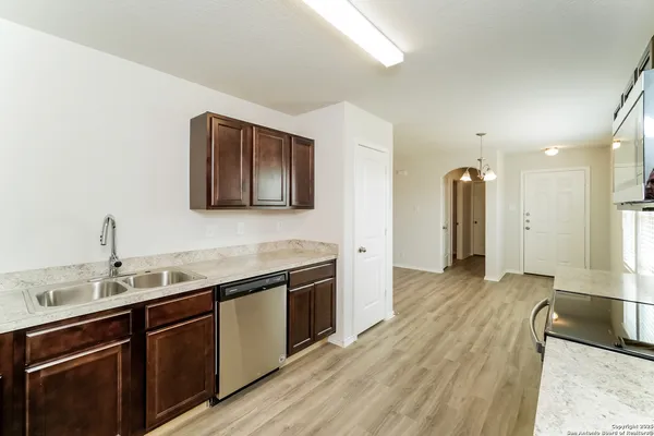 a kitchen with stainless steel appliances granite countertop a sink and a stove top oven