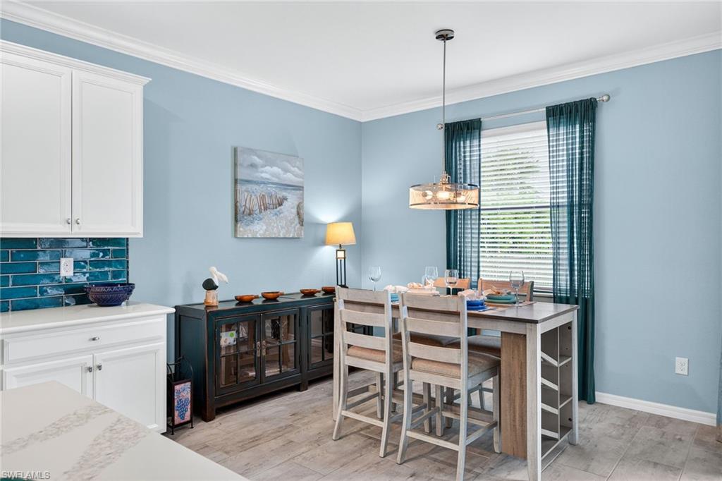 19169 Elston Way Estero, FL 33928 - Photo 12 of 44 a dining room with furniture and window