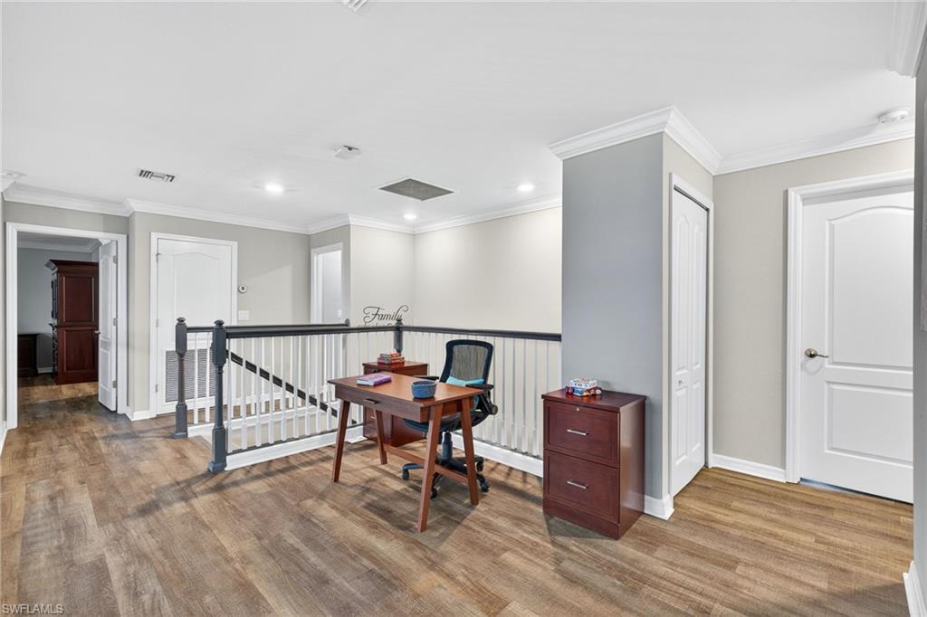 19169 Elston Way Estero, FL 33928 - Photo 24 of 44 a view of a hallway with wooden floor and furniture