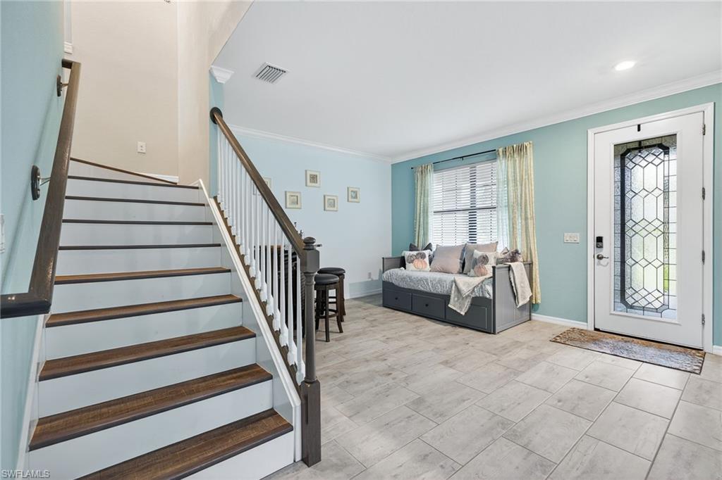 19169 Elston Way Estero, FL 33928 - Photo 4 of 44 a living room with furniture and a floor to ceiling window