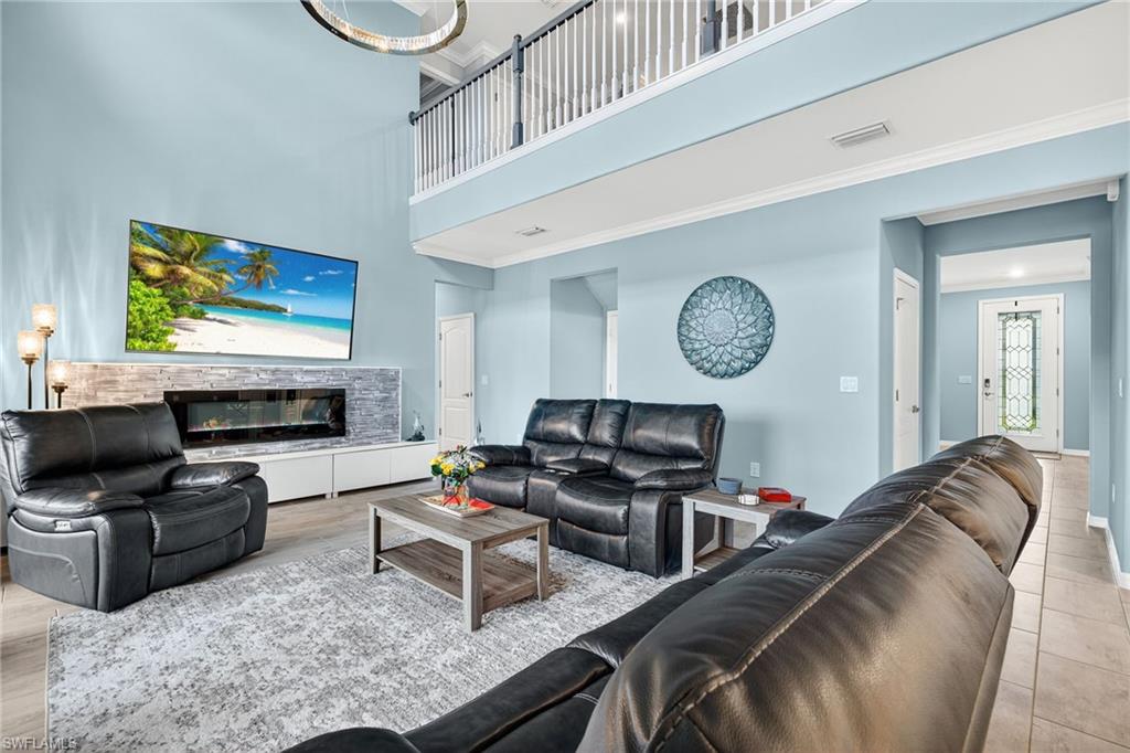 19169 Elston Way Estero, FL 33928 - Photo 5 of 44 a living room with furniture and a flat screen tv