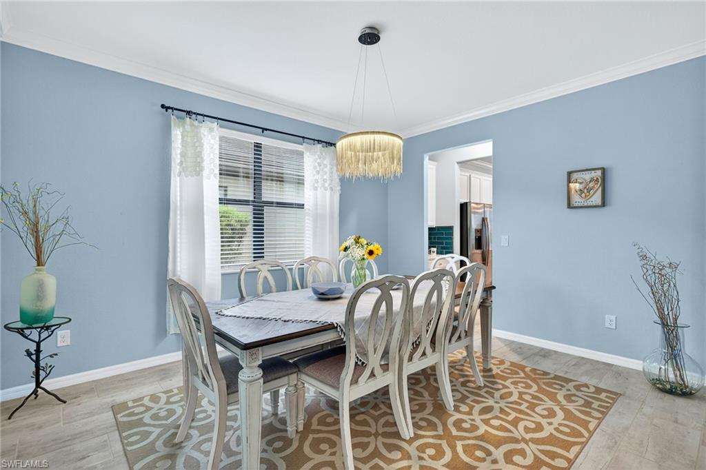 19169 Elston Way Estero, FL 33928 - Photo 8 of 44 a view of a dining room with furniture and chandelier