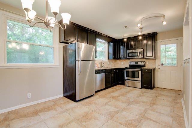 407 Burch Road Clarksville, TN 37042 - Photo 4 of 24 a kitchen with stainless steel appliances a refrigerator a stove a sink a microwave and island