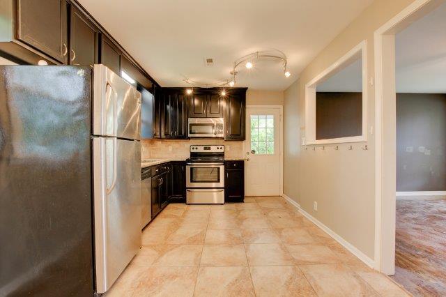 407 Burch Road Clarksville, TN 37042 - Photo 5 of 24 a kitchen with stainless steel appliances a refrigerator and a stove top oven