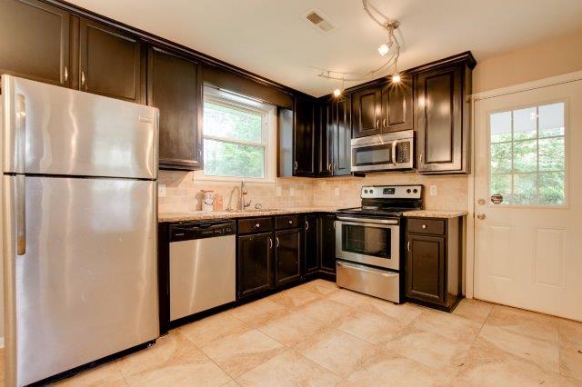 407 Burch Road Clarksville, TN 37042 - Photo 6 of 24 a kitchen with stainless steel appliances a refrigerator sink and stove