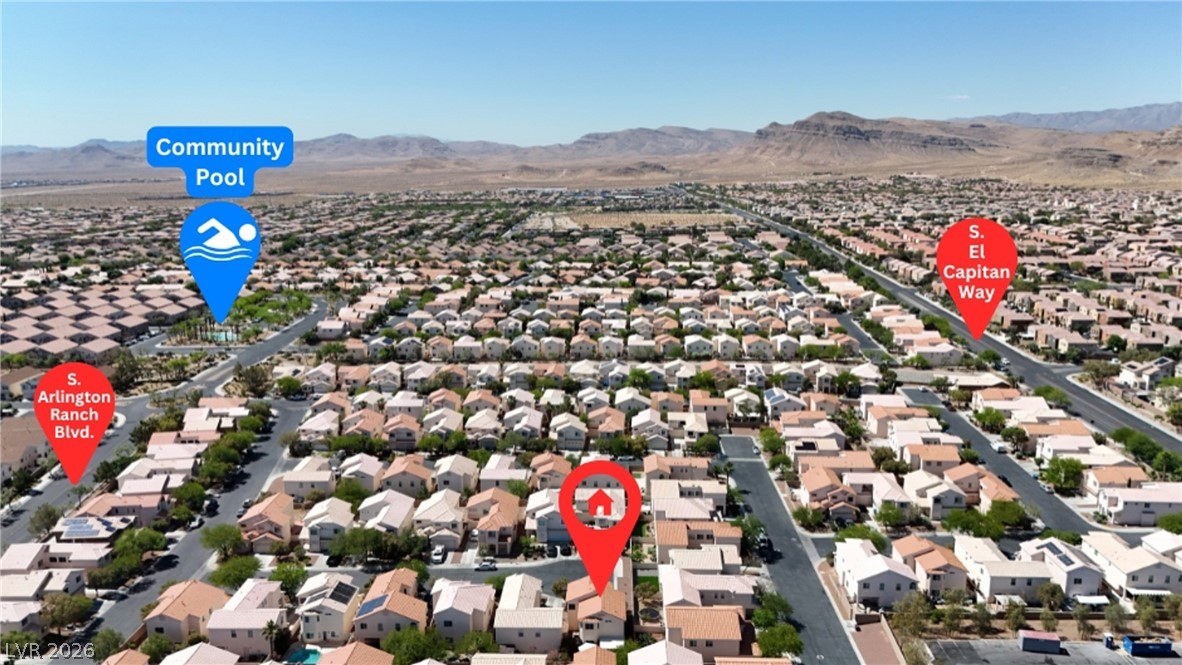 8934 Deep Ridge Court Las Vegas, NV 89178 - Photo 37 of 47 An aerial perspective showcases a vibrant community nestled among the mountains, complete with a shared pool.