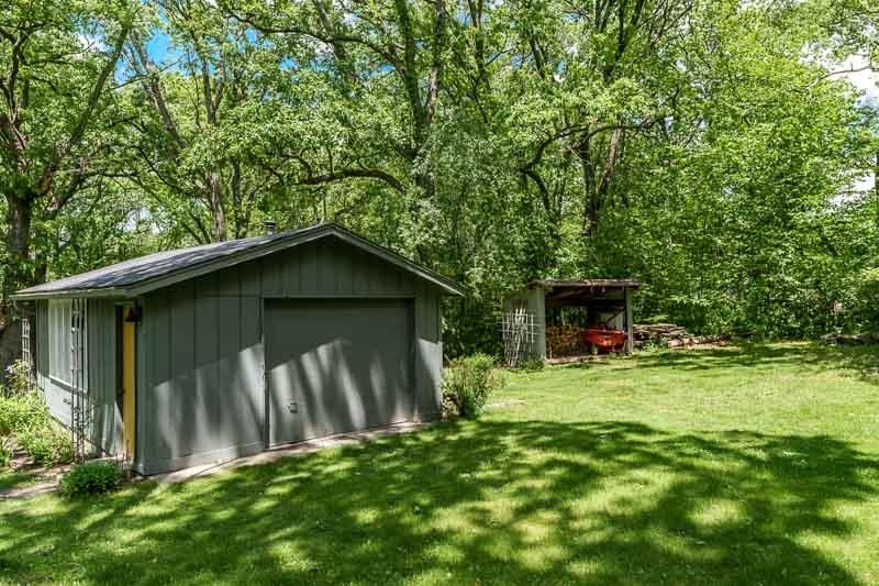 8724 Burr Oak Road Roscoe, IL 61073 - Photo 54 of 59 a backyard of a house with plants and large tree