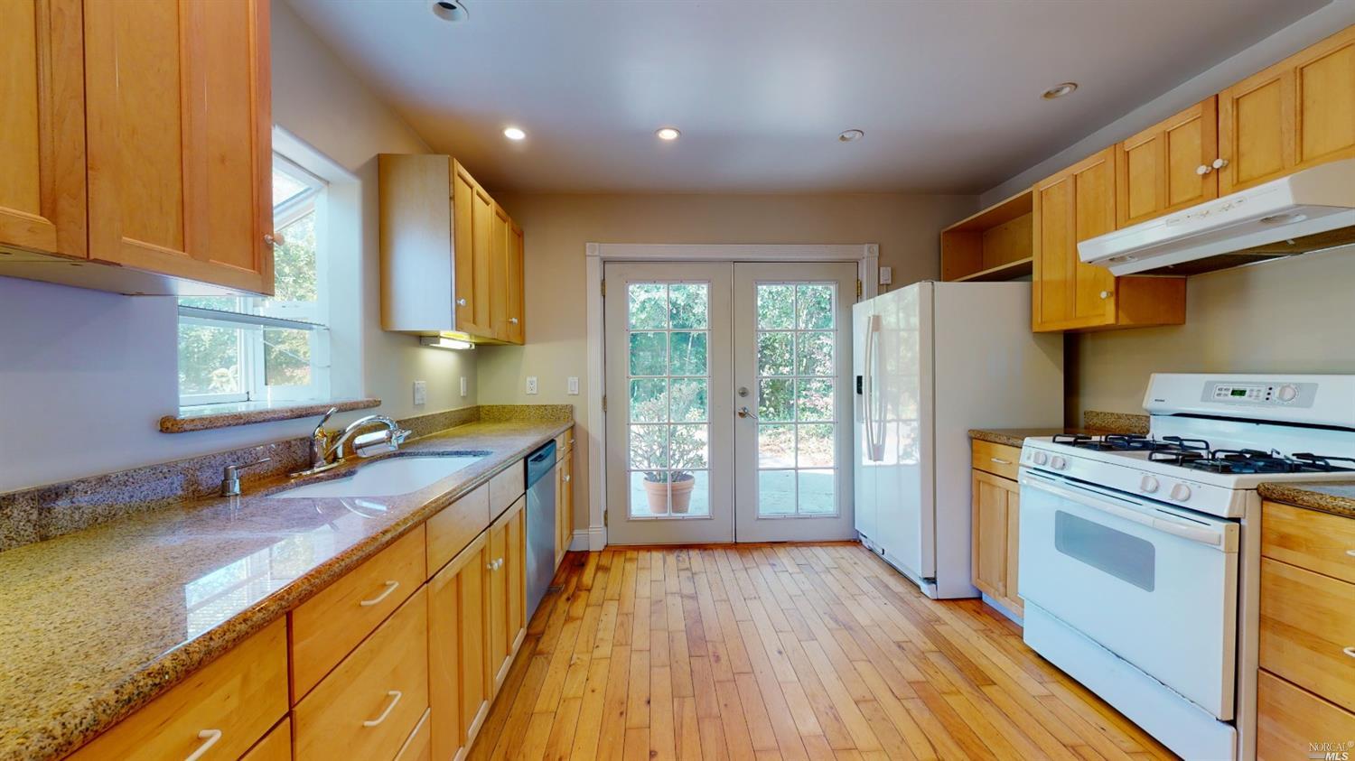77 Homestead Boulevard Mill Valley, CA 94941 - Photo 11 of 56 a kitchen with a sink a wooden floor and a large window