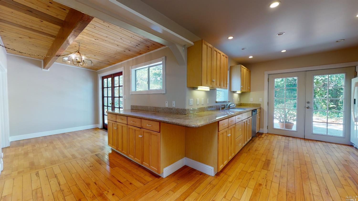 77 Homestead Boulevard Mill Valley, CA 94941 - Photo 15 of 56 a kitchen with stainless steel appliances granite countertop a stove a sink and a large window