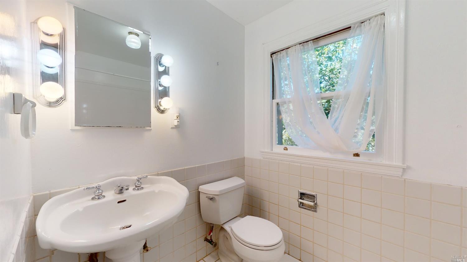 77 Homestead Boulevard Mill Valley, CA 94941 - Photo 25 of 56 a bathroom with a sink a toilet and mirror