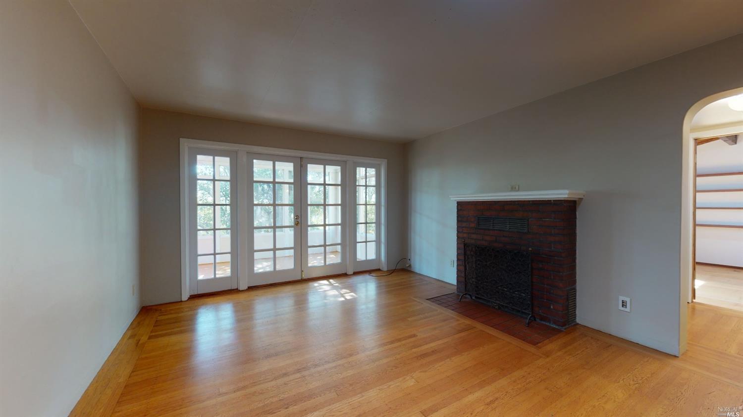 77 Homestead Boulevard Mill Valley, CA 94941 - Photo 26 of 56 an empty room with wooden floor and windows