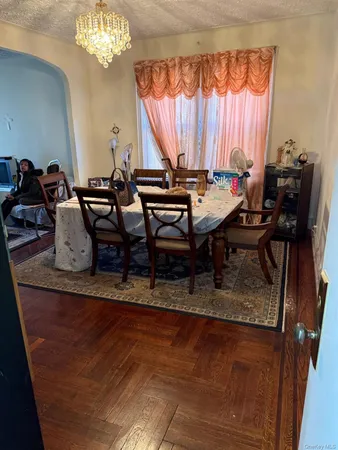 a dining room with furniture a chandelier and a rug