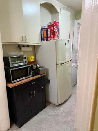 a white refrigerator freezer sitting inside of a kitchen