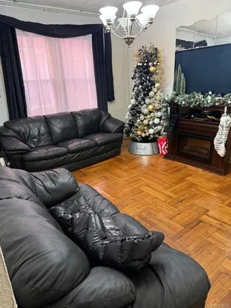 a living room with a couch and a chandelier