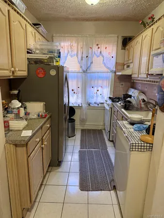 a kitchen with a sink a stove and cabinets