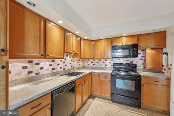 a kitchen with a sink stove and microwave