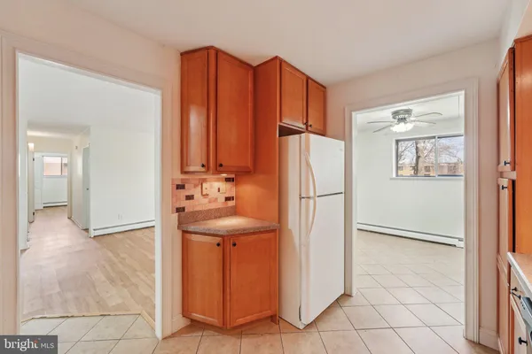 a kitchen with stainless steel appliances a refrigerator and a cabinets