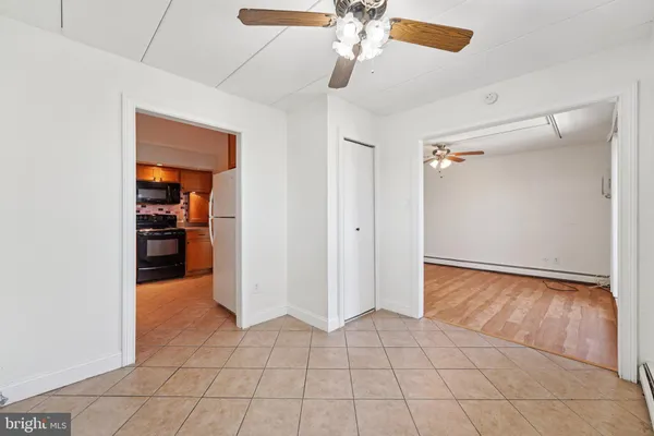 a view of a livingroom with an empty space and a ceiling fan
