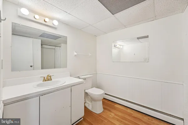 a bathroom with a sink a toilet and a mirror