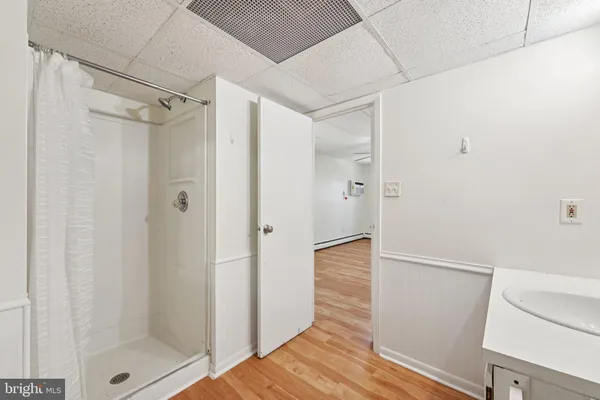 a bathroom with a shower and a glass door
