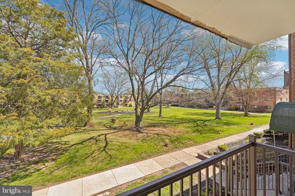 a view of a yard with wooden fence