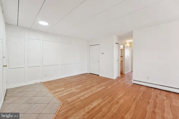 a view of empty room with wooden floor