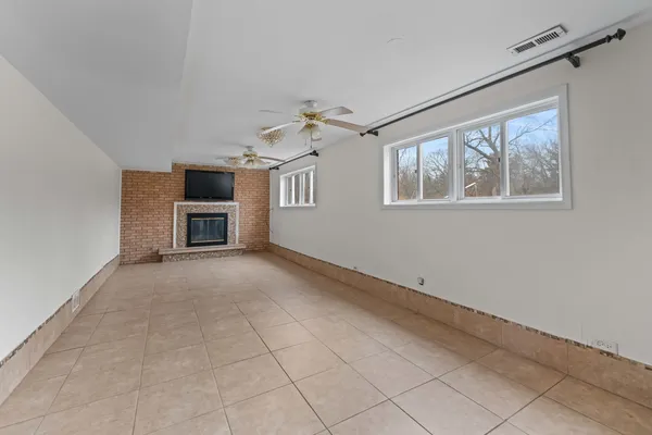 a view of main area with furniture and ceiling fan