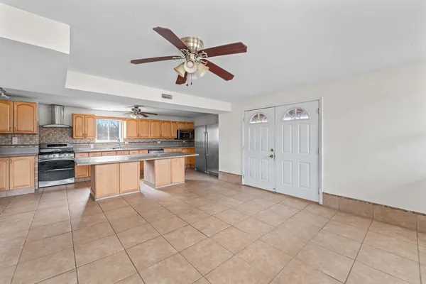 a large kitchen with cabinets and stainless steel appliances