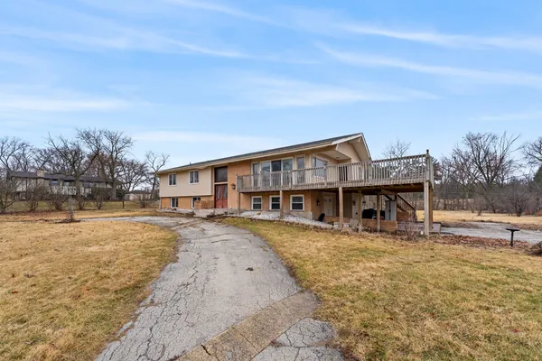 a view of a house next to a big yard