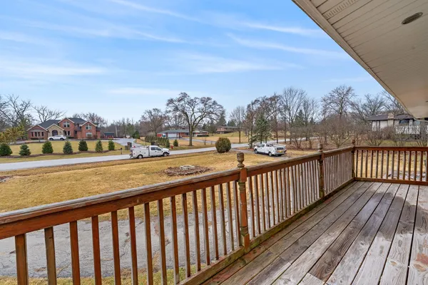 a view of a balcony with wooden floor