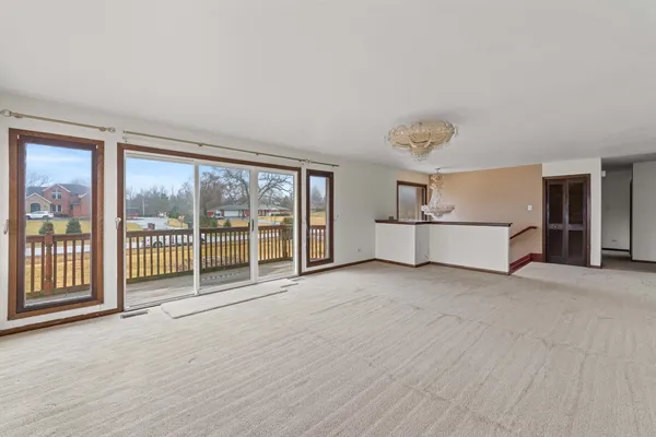 a view of a big room with wooden floor and windows