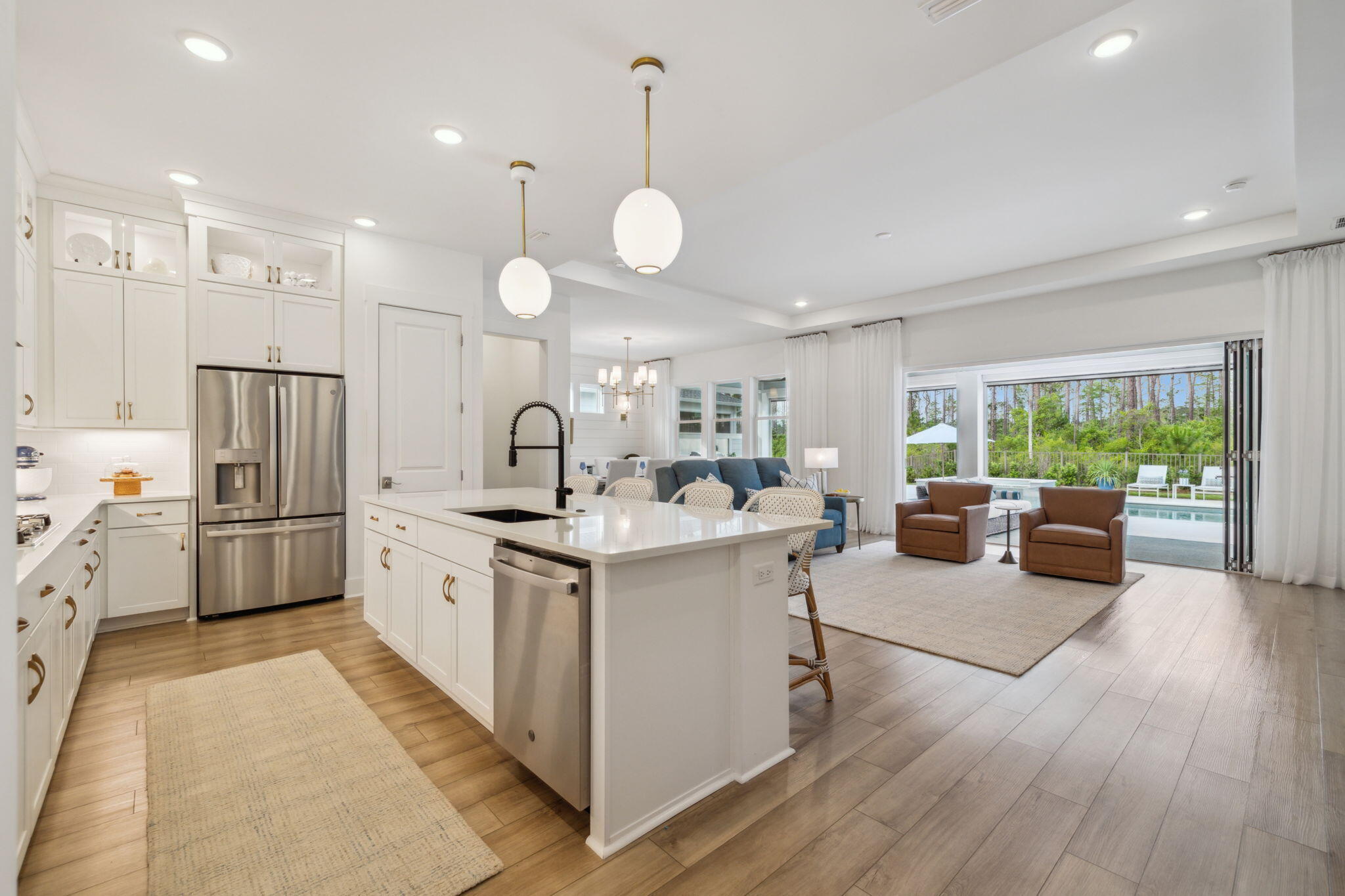 282 West Lafayette Rd Inlet Beach Inlet Beach, FL 32461 - Photo 9 of 40 a kitchen with stainless steel appliances a stove top oven a refrigerator a dining table and chairs with wooden floor