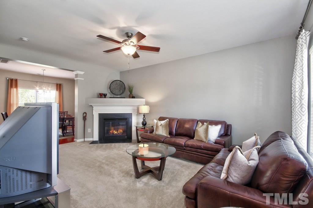 4225 Hopper Street Raleigh, NC 27616 - Photo 2 of 19 a living room with furniture a fireplace and a window