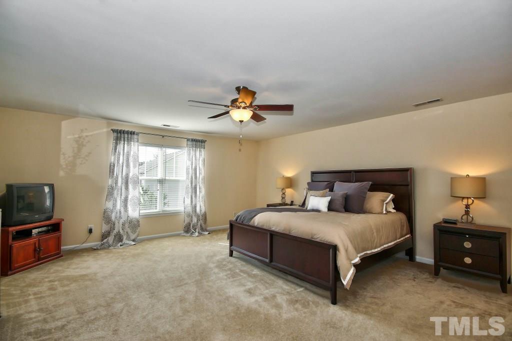 4225 Hopper Street Raleigh, NC 27616 - Photo 15 of 19 a bedroom with a bed and a tv