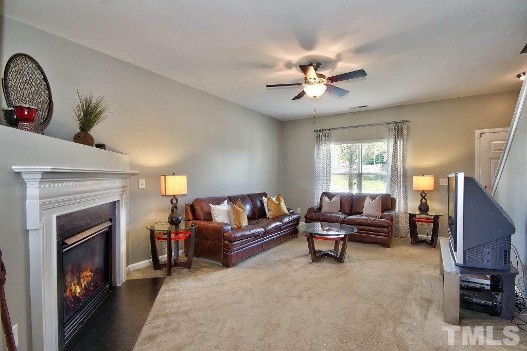 4225 Hopper Street Raleigh, NC 27616 - Photo 3 of 19 a living room with furniture and a fireplace