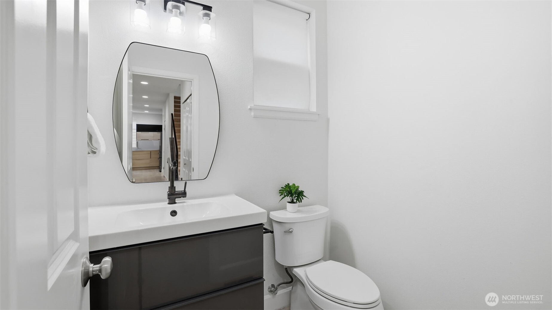 16102 Parkside Way Southeast Renton, WA 98058 - Photo 12 of 27 a bathroom with a toilet sink and mirror