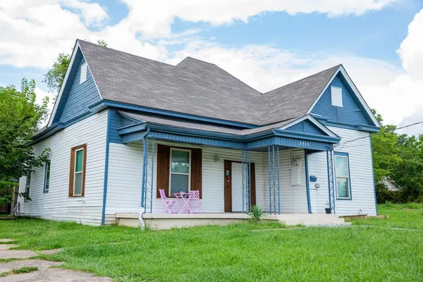 a front view of a house with a yard and porch