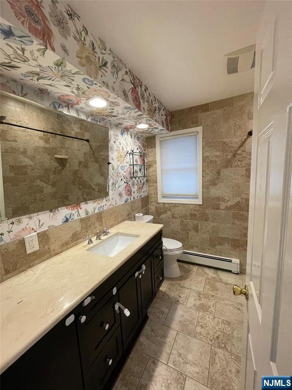 70 Suters Lane Wayne, NJ 07470 - Photo 11 of 22 a bathroom with a granite countertop sink a toilet a mirror and shower