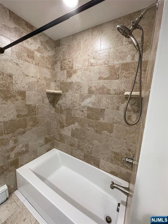 70 Suters Lane Wayne, NJ 07470 - Photo 12 of 22 a bathroom with a white bath tub and a shower