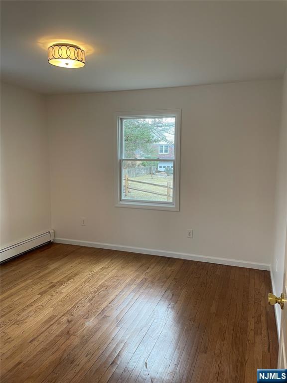 70 Suters Lane Wayne, NJ 07470 - Photo 7 of 22 a view of an empty room with wooden floor and a window