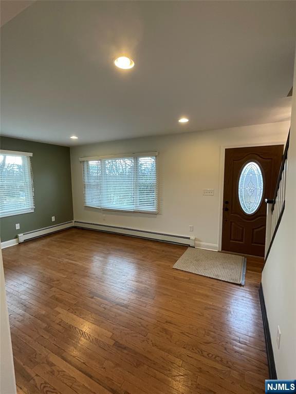70 Suters Lane Wayne, NJ 07470 - Photo 8 of 22 an empty room with wooden floor and windows