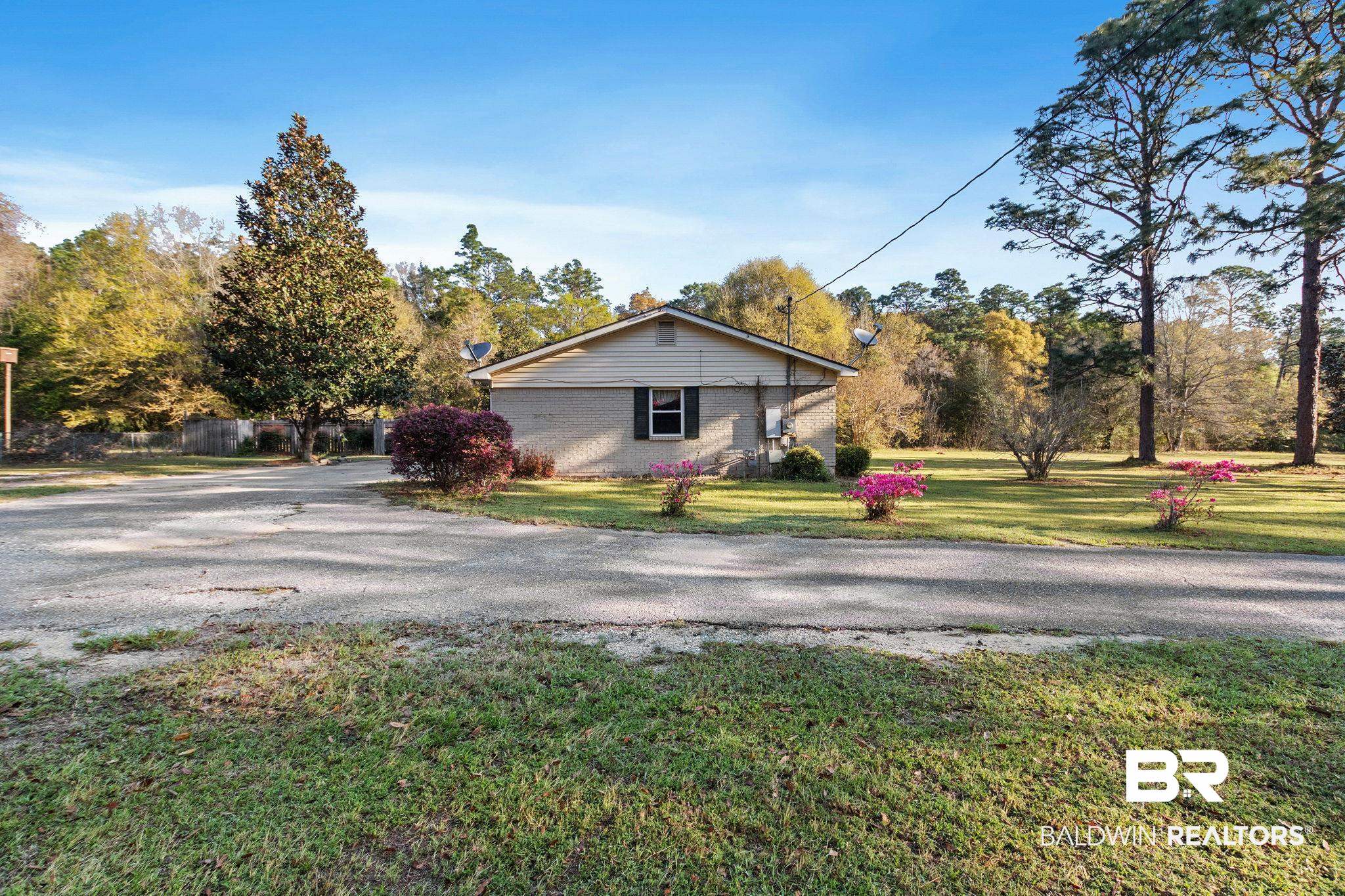 3864 Leroy Stevens Road Mobile, AL 36619 - Photo 31 of 33 View of front of home featuring asphalt driveway, brick siding, and a front lawn