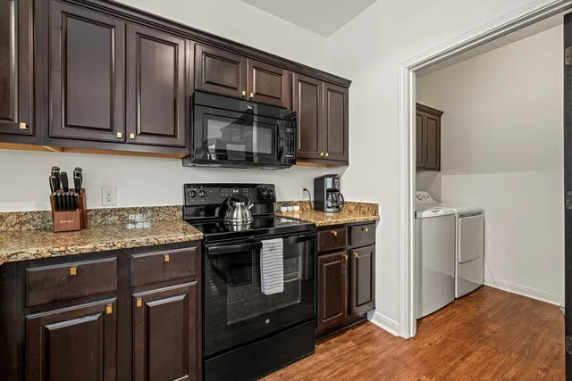 a kitchen with stainless steel appliances granite countertop a stove and a microwave