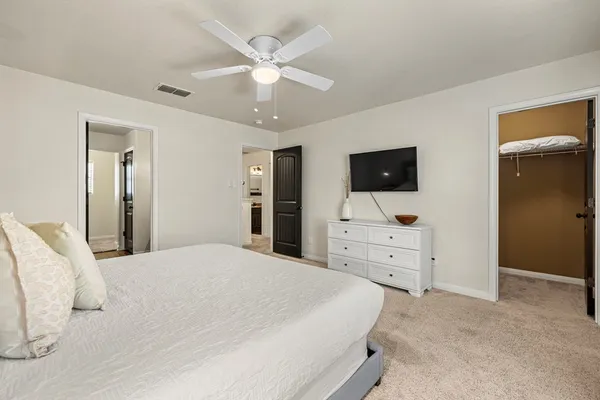 a bedroom with a bed and a flat screen tv