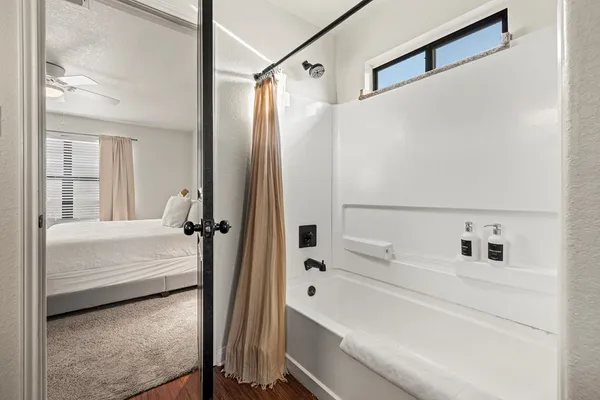 a bathroom with a tub and a shower