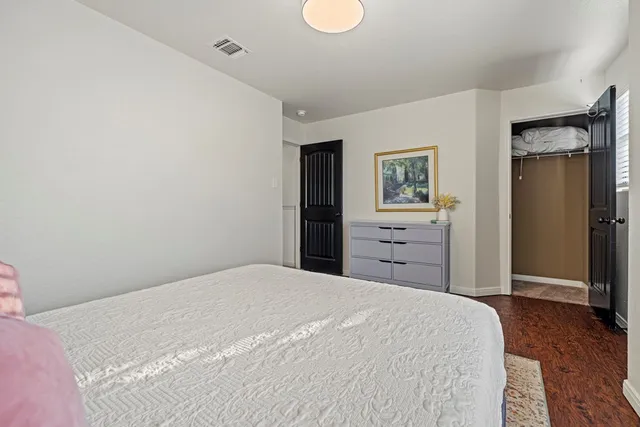 a bedroom with a bed and a dresser