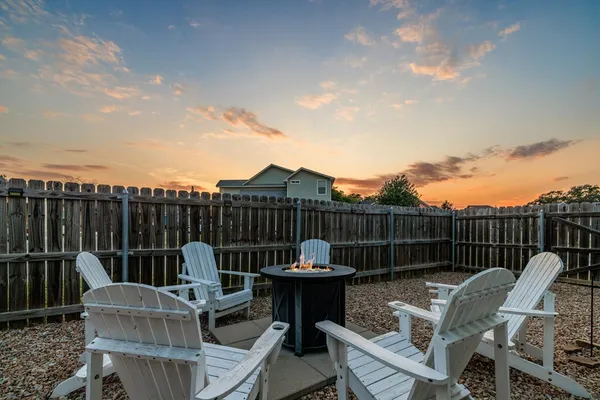 a view of a roof deck with furniture