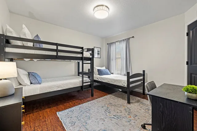 a living room with furniture a rug and a wooden floor