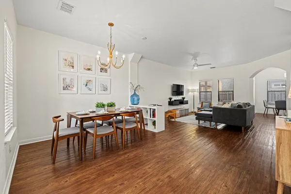 a living room with furniture dining table and a wooden floor