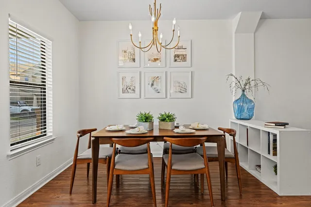 a view of a dining room with furniture and wooden floor